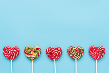 Sweet lollipops on a stick on a monochromatic background. Stylish valentine's day card. Bright and...