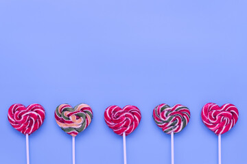Sweet lollipops on a stick on a monochromatic background. Stylish valentine's day card. Bright and...