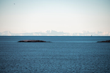 Sharp, italian Alps peaks visible across the adriatic sea off the coast of Rovinj, Croatia