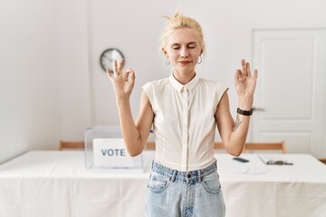 Beautiful caucasian woman standing by voting ballot at election room relax and smiling with eyes...