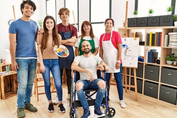 Group of young artists people at art studio looking positive and happy standing and smiling with a confident smile showing teeth