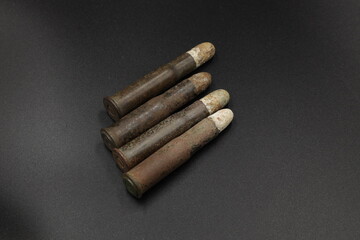Old cartridges for rifle on black background