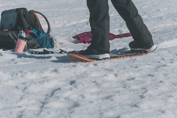 A close-up shot of a Caucasian man sliding down a slope on a snow skate at a ski resort in France