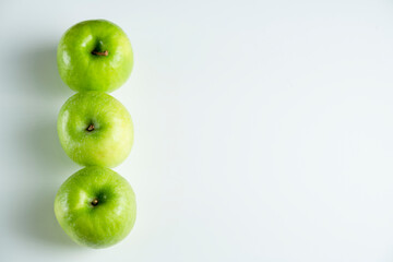 a whole green apple on a white background