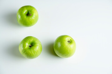 a whole green apple on a white background