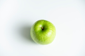 a whole green apple on a white background
