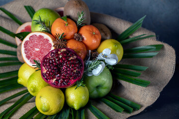 bouquet of fruits, from apple, orange, lemon, pomegranate, grapefruit and palm branch