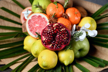 bouquet of fruits, from apple, orange, lemon, pomegranate, grapefruit and palm branch