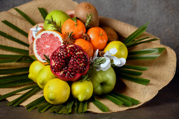 bouquet of fruits, from apple, orange, lemon, pomegranate, grapefruit and palm branch