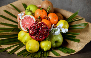 bouquet of fruits, from apple, orange, lemon, pomegranate, grapefruit and palm branch