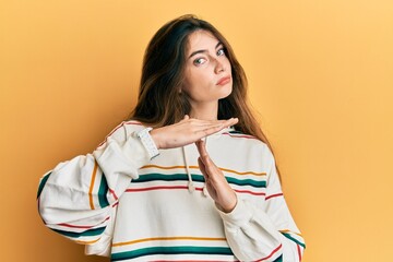 Young caucasian woman wearing casual clothes doing time out gesture with hands, frustrated and...