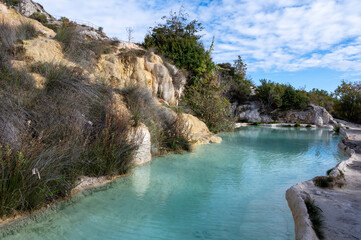 Ancient hot thermal springs and blue pool in nature park Dei Mulini, Bagno Vignoni, Tuscany, Italy