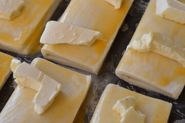 hand-made dough, stuffed with cheese with butter on top, ready to bake in the oven