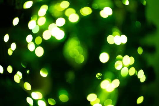 Bokeh green on a black background. Blur and bokeh abstract , vibrant colors and textured. Good wallpapers .Copy space.