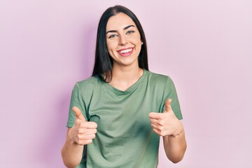 Beautiful woman with blue eyes wearing casual t shirt success sign doing positive gesture with hand, thumbs up smiling and happy. cheerful expression and winner gesture.