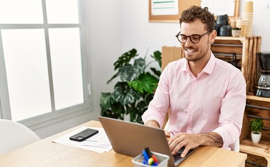 Young hispanic man smiling confident working at office