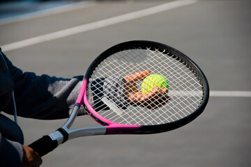 someone holding tennis ball and racket