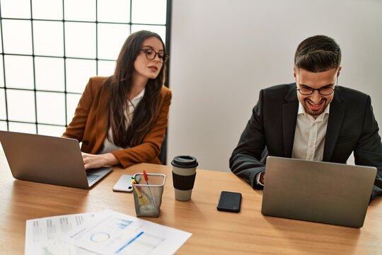 Hispanic business worker working and spying partner at the office.