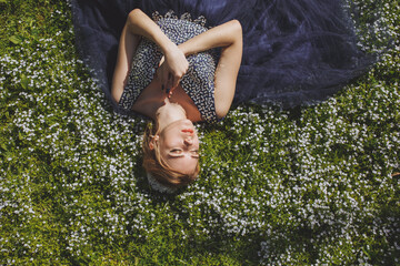 The beautiful woman in a dress in the forest.