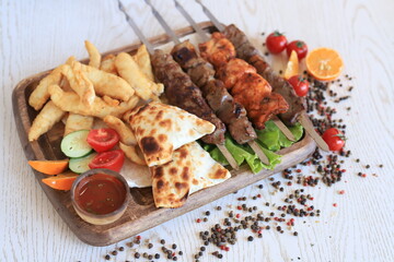 Uzbek kebab, shashlik, barbeque, samsa and fried carp fillet
