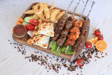 Uzbek kebab, shashlik, barbeque, samsa and fried carp fillet