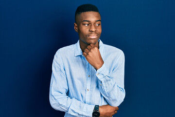 Young african american man wearing casual clothes with hand on chin thinking about question, pensive expression. smiling with thoughtful face. doubt concept.