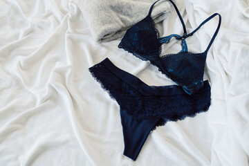 Navy Blue Bra and Thong with Gray Sweater on White Background with Copy Space