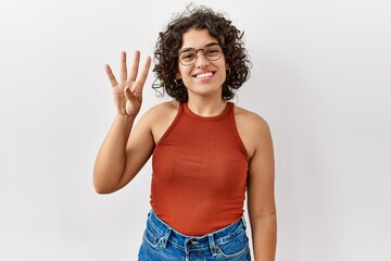 Young hispanic woman wearing glasses standing over isolated background showing and pointing up with fingers number four while smiling confident and happy.