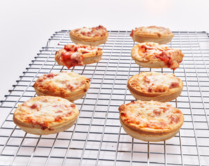  Group of small prosciutto italian pizza on oven steel tray isolated over white background