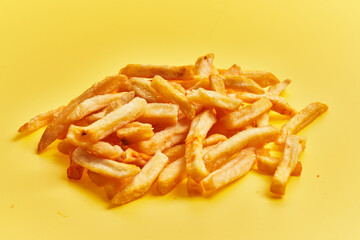  Bunch of french fried potatoes over yellow background