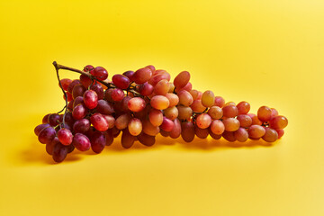  Bunch of grapes over yellow background