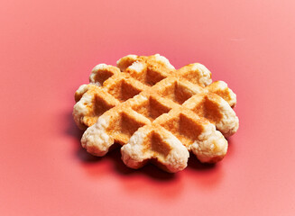  Single delicious waffle over red background