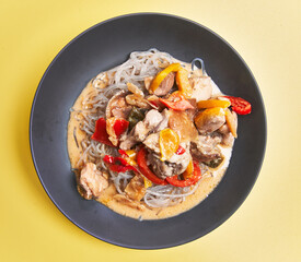  Plate of delicious rice noodles over yellow background