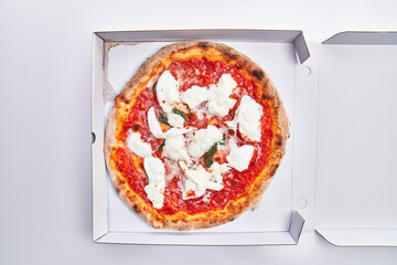  Single margherita italian pizza on delivery box isolated over white background