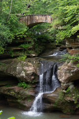 Fototapeta na wymiar Water under the bridge waterfall in forest Ohio
