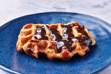  Plate of delicious waffle with chocolate on marble surface