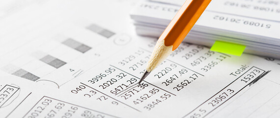 Naklejka na ściany i meble Accounting document with pencil and checking financial chart. Concept of banking, financial report and financial audit.