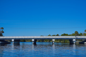 Obraz premium beautiful tree, clear water, and house along homossasa river in winter. 