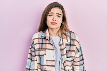 Fototapeta premium Young caucasian girl wearing casual clothes looking sleepy and tired, exhausted for fatigue and hangover, lazy eyes in the morning.