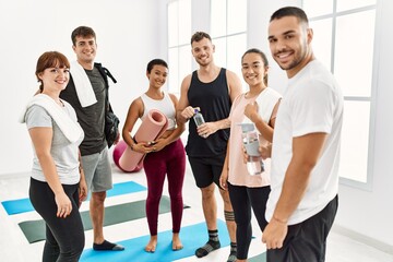 Naklejka premium Group of young sporty people smiling happy and looking to the camera at sport center.