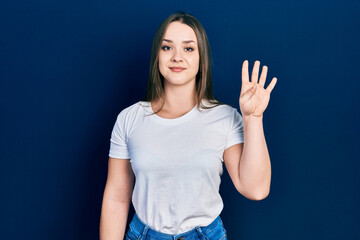 Young hispanic girl wearing casual white t shirt showing and pointing up with fingers number four while smiling confident and happy.