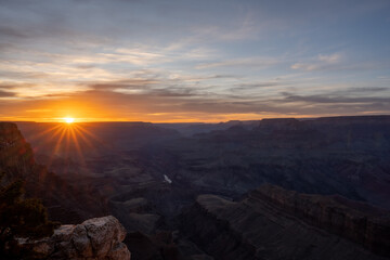 Fototapeta na wymiar Orange Sunburst Lights Up the Horizon of the Grand Canyon