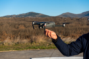 Person receiving a drone in hand