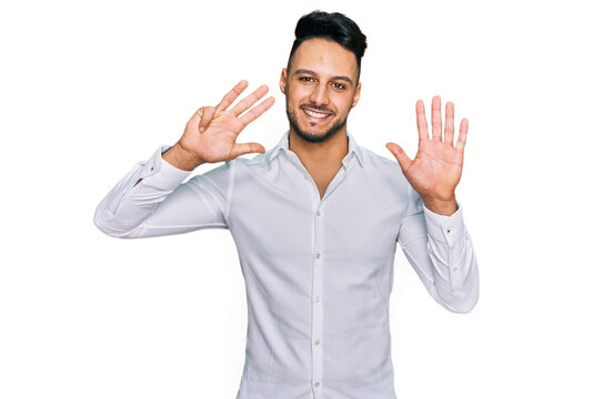 Young arab man wearing casual clothes showing and pointing up with fingers number nine while smiling confident and happy.