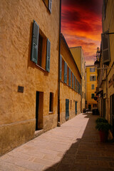 Fototapeta na wymiar Pastel buildings on narrow street of Ajaccio