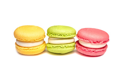 Banner of colorful macaroons isolated on white background. Lemon yellow, strawberry pink and green french cookies. Caramel hazelnut and strawberry cakes in front view. Bakery concept with blank space
