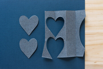 gray heart shapes on a fancy paper and wood background