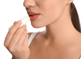 Young woman applying lip balm on white background, closeup - obrazy, fototapety, plakaty