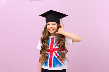 the student shows a hand gesture that she is calling on the phone. a schoolgirl with the flag of England on her T-shirt. a beautiful girl on an isolated pheolete background.