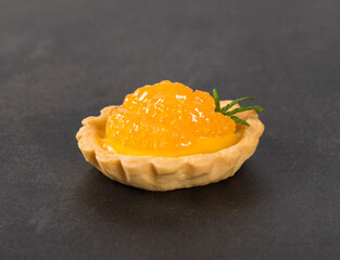 Citrus Tartlet on a dark gray background